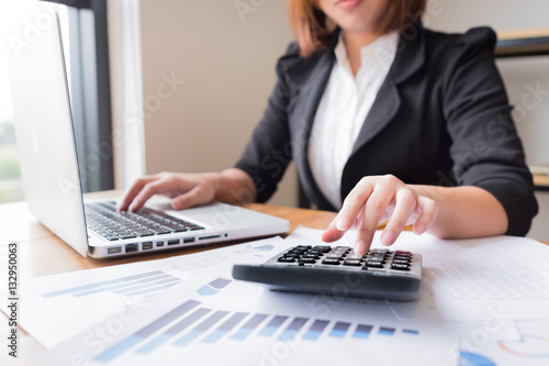 Asian female accountant or banker making calculations. Savings,