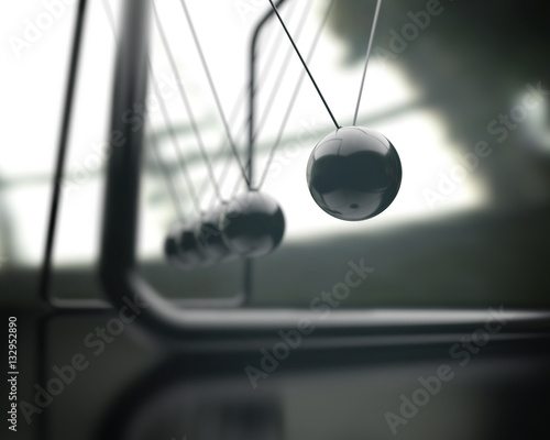 Newton's cradle, concept of conservation of momentum and energy. © ktsdesign