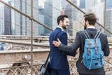 USA, New York City, two businessmen on Brooklyn Bridge