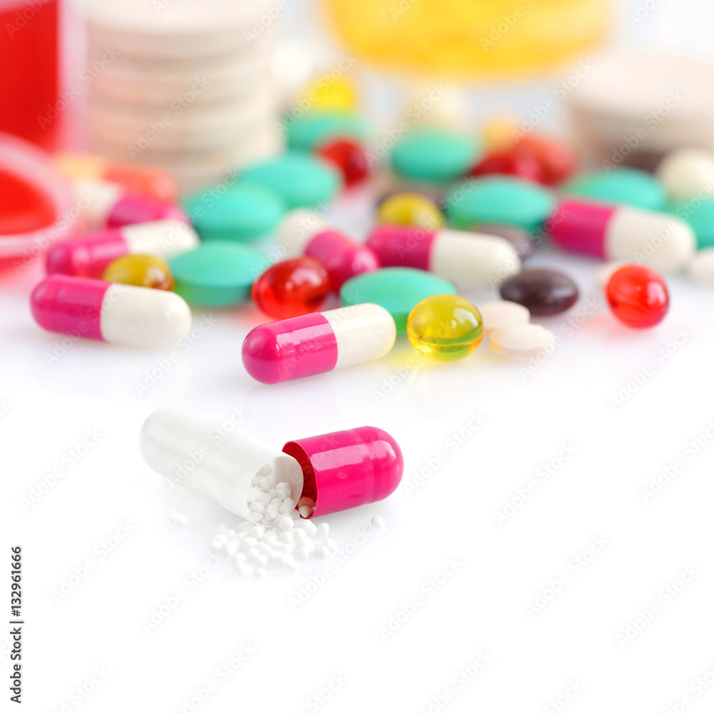 Colored pills, capsules and vitamins isolated on a white background Colored pills, capsules and vitamins isolated on a white background
