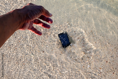 The Phone Camera fall to the water on the beach. 