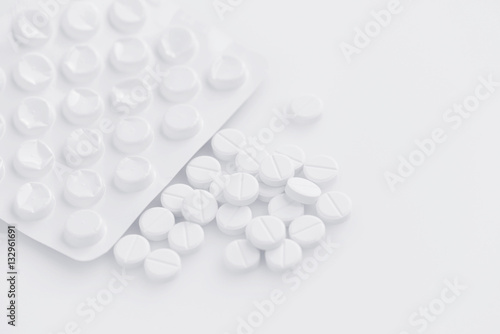 White pills on a white background (with space for text)