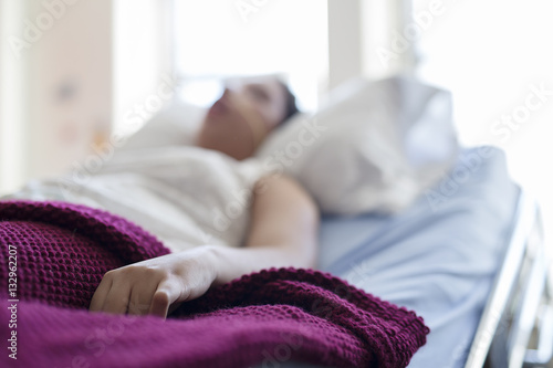 Sick patient lying on bed in hospital for medical background photo