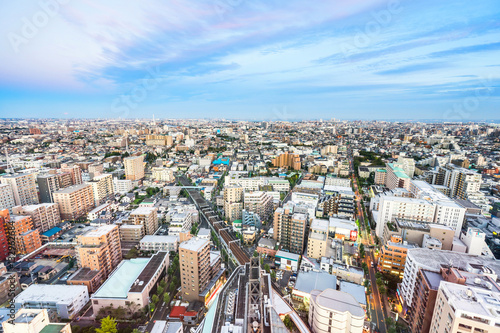 Business and culture concept - panoramic modern city skyline bird eye aerial view under dramatic sunset glow and beautiful cloudy sky in Tokyo  Japan