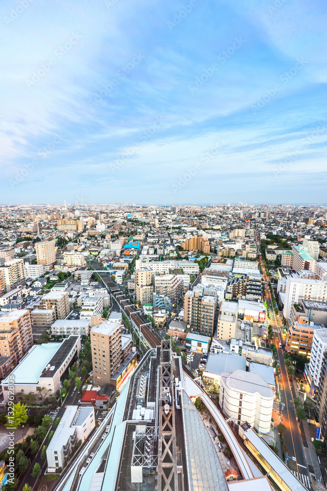 Fototapeta premium Business and culture concept - panoramic modern city skyline bird eye aerial view under dramatic sunset glow and beautiful cloudy sky in Tokyo, Japan
