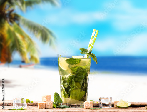 Mojito lime drinks on wood with blur beach background photo