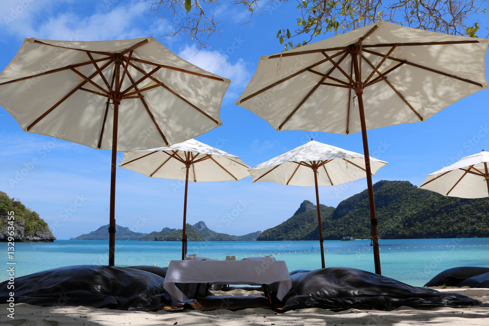 White umbrella and air cushion seat on the beach in Thailand. 