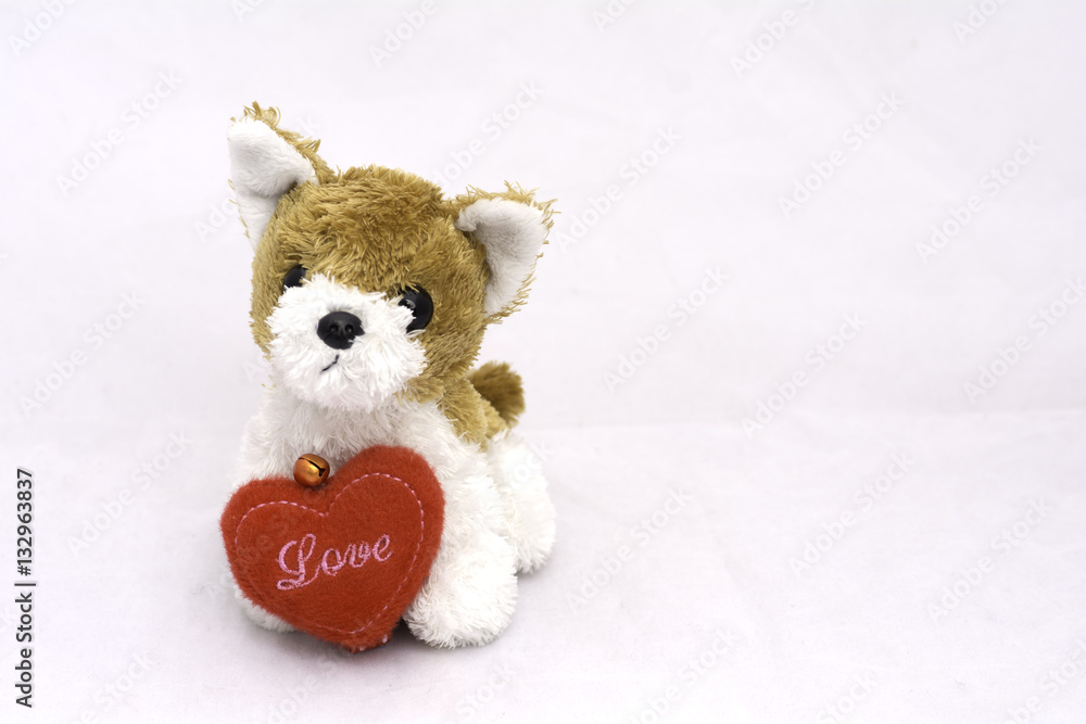 dog doll with red heart on white background