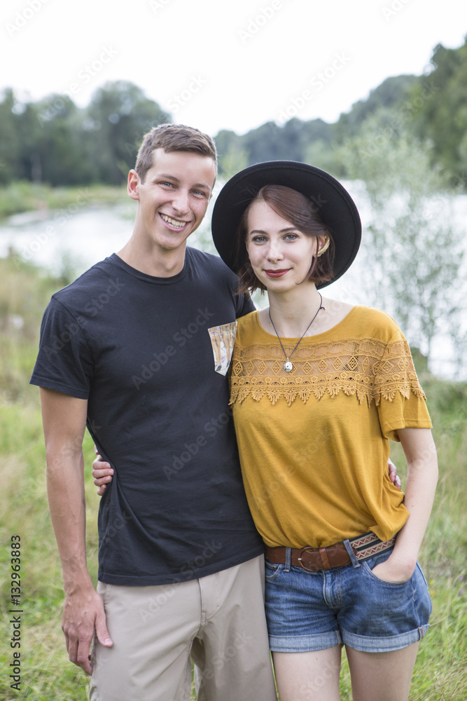 Portrait of happy couple standing on the river bank Portrait of happy couple standing on the river bank
