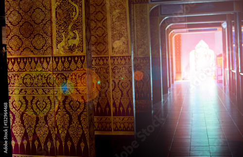 opening door of thai temple with sunlight and lai thai