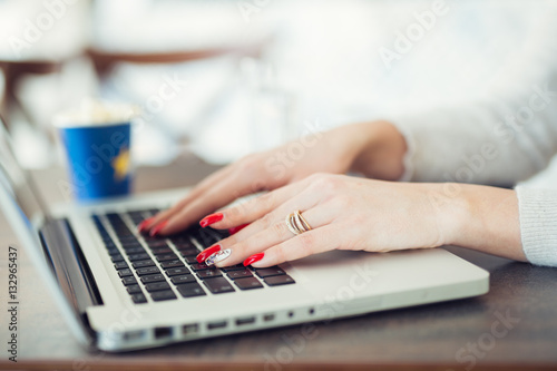 Woman working at home office hand on keyboard close up