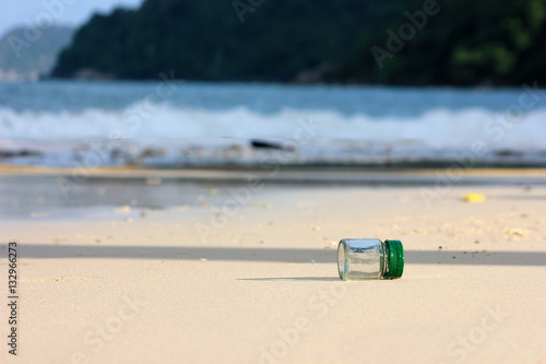 Beverage bottle with shade from the sun on the beach 
