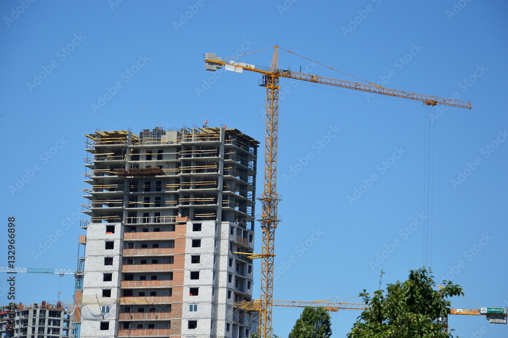 Construction of a skyscraper monolith and brick construction elements from a number of tower crane. Construction of a skyscraper monolith and brick construction elements from a number of tower crane.