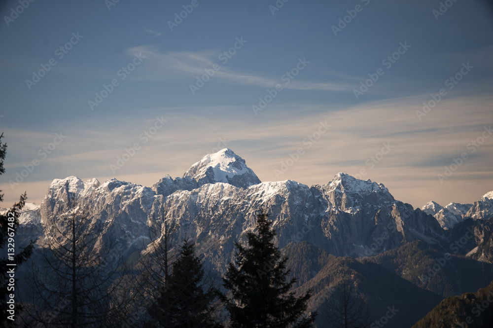 Panorama of beautiful snowy mountains on a sunny day in winter time. Julian Alps, Europe.