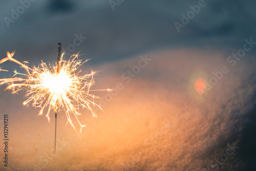 Sparkler in the snow in the evening