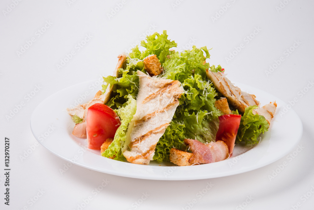 salad with bacon, tomatoes and croutons on a white plate salad with bacon, tomatoes and croutons on a white plate