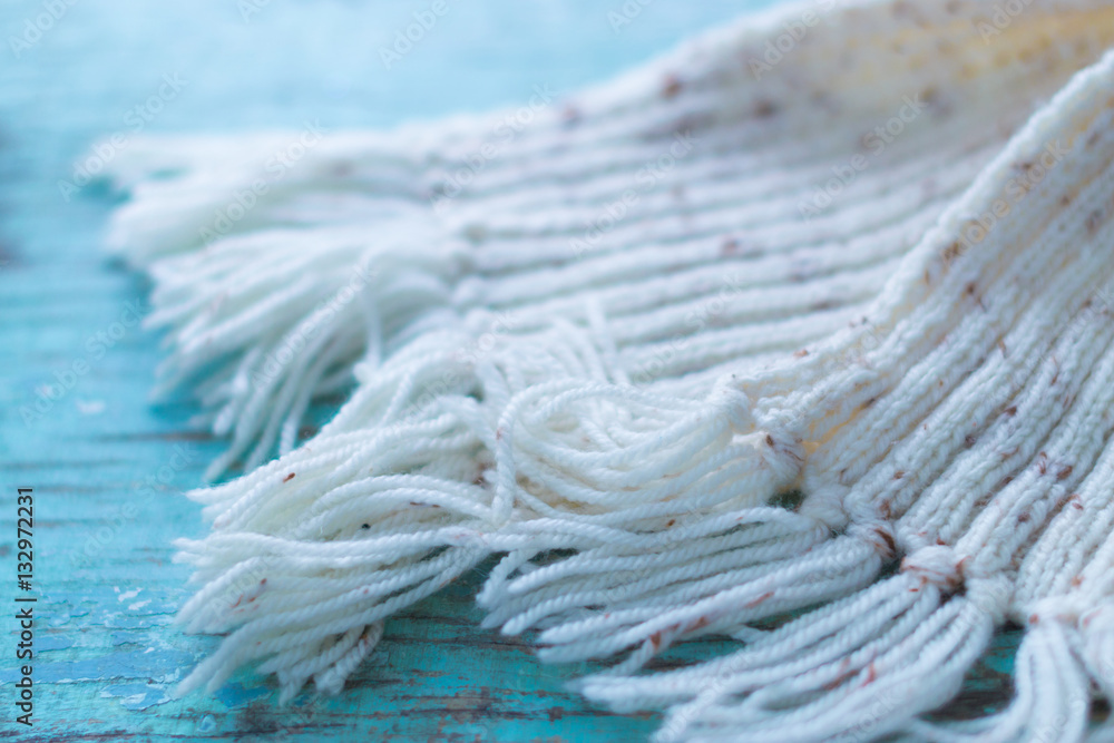 Knitted winter scarf on wooden boards Knitted winter scarf on wooden boards