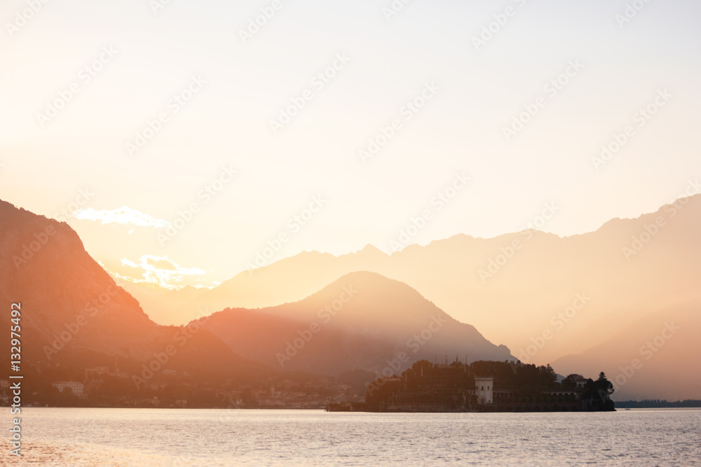 Mountains and sunlight. Sea and town at distance. Go travelling around the world.