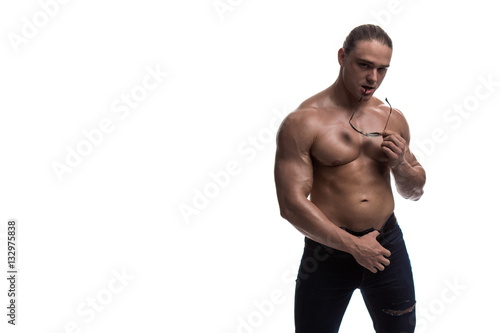 Fotografie portrait of a brutal male bodybuilder with sunglasses on a white background