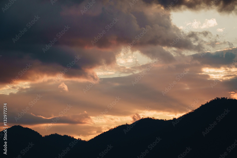 Sunset Behind Mountain in the rainy season Sunset Behind Mountain in the rainy season