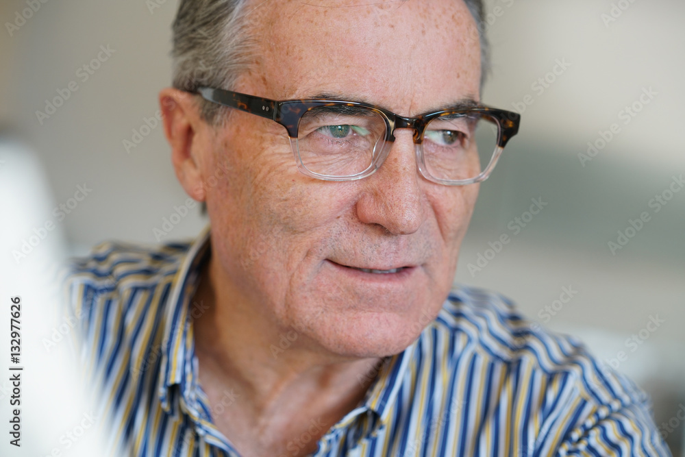 Senior man with eyeglasses reading newspaper Senior man with eyeglasses reading newspaper