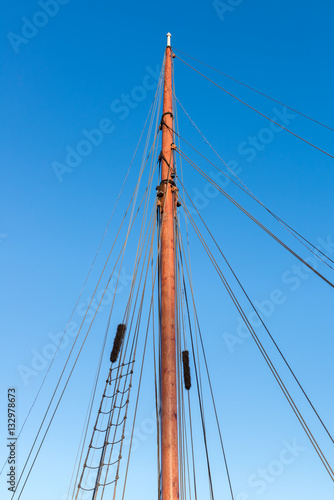 mast sailing yacht in the background of blue sky