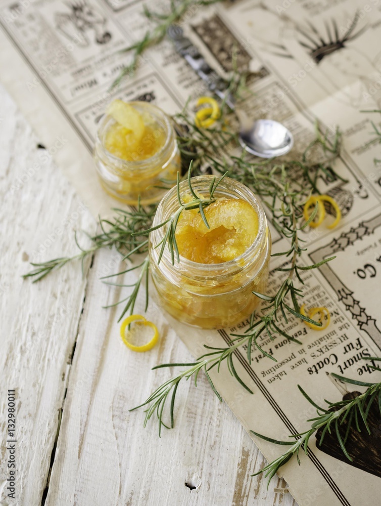 orange marmalade in small glass jars with rosemary, selective focus orange marmalade in small glass jars with rosemary, selective focus