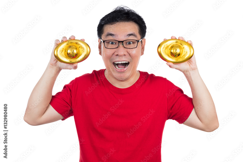 Happy Asian Chinese man wearing red shirt holding ingot Happy Asian Chinese man wearing red shirt holding ingot