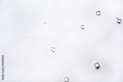 Gun holes on paper.