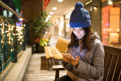 Woman using cellphone at night