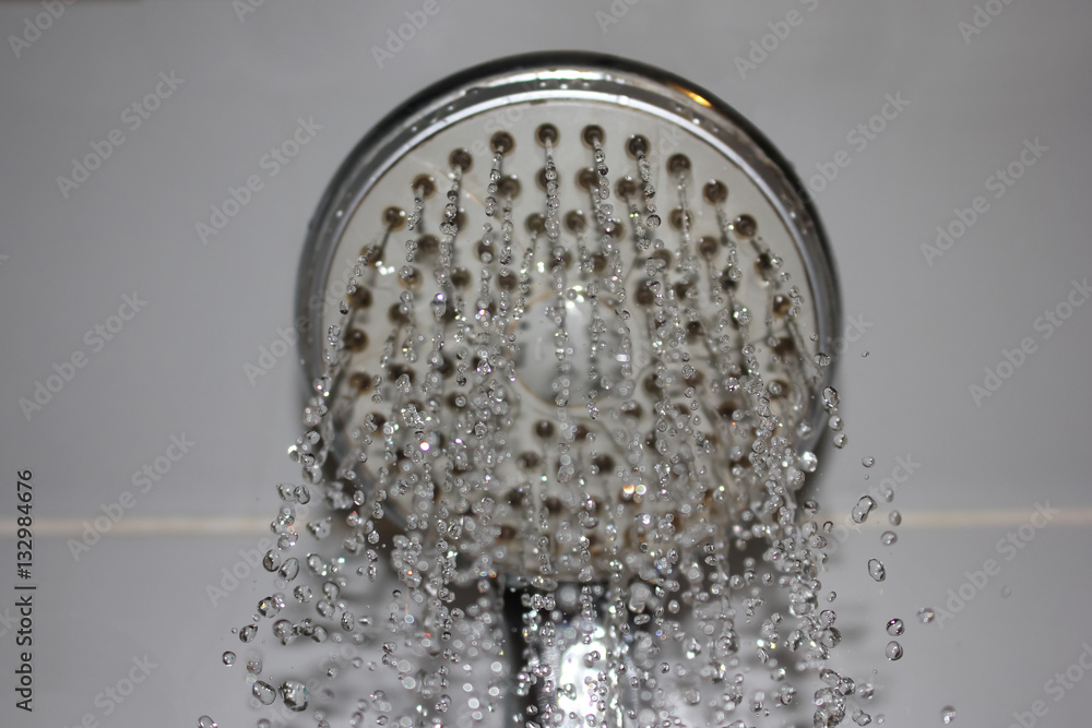 Water flowing from the shower with the reflected light from the lamp. Water flowing from the shower with the reflected light from the lamp.