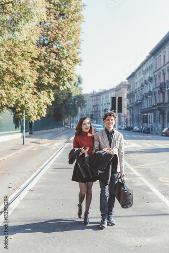 Wallpaper Mural Young beautiful couple in love chatting walking outdoor in the city, having fun - first date,  romantic, love concept Torontodigital.ca