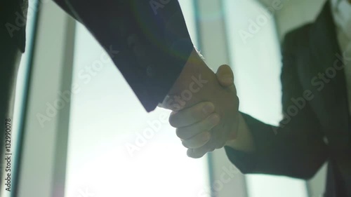 Two business partner shake hands when meeting. In slow motion