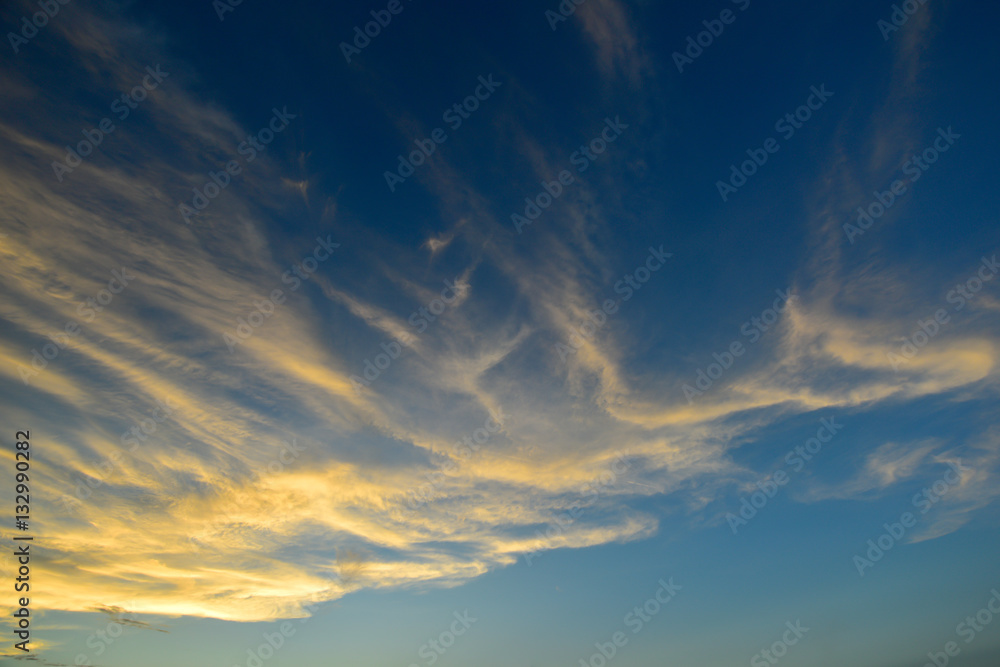 Fluffy clouds with sunlight effect on blue sky before sunset