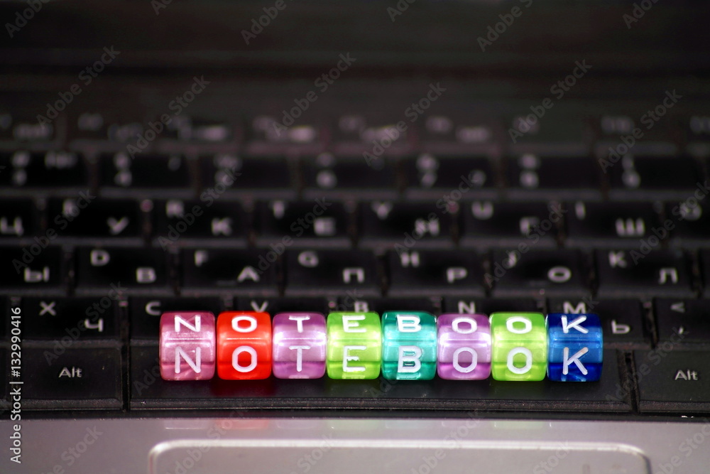 word Notebook of multicolored dice-letters, white chars