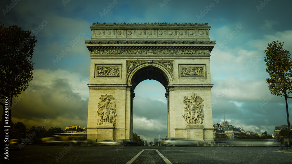 Triumphal Arch in Paris with traffic cars from Champs Elysees Triumphal Arch in Paris with traffic cars from Champs Elysees
