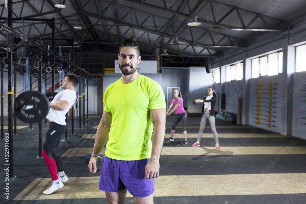 Men doing strength training in gym Men doing strength training in gym