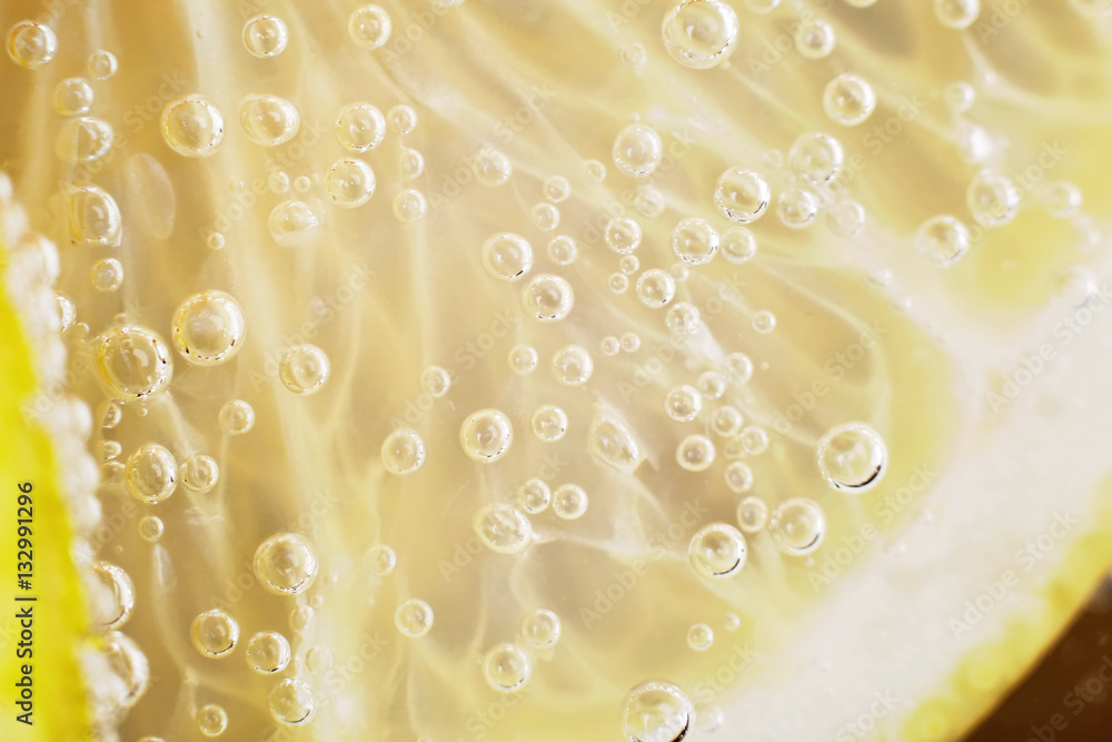 Lemon in the water with bubbles close up Lemon in the water with bubbles close up