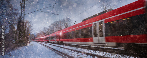 red train speeding in the snow