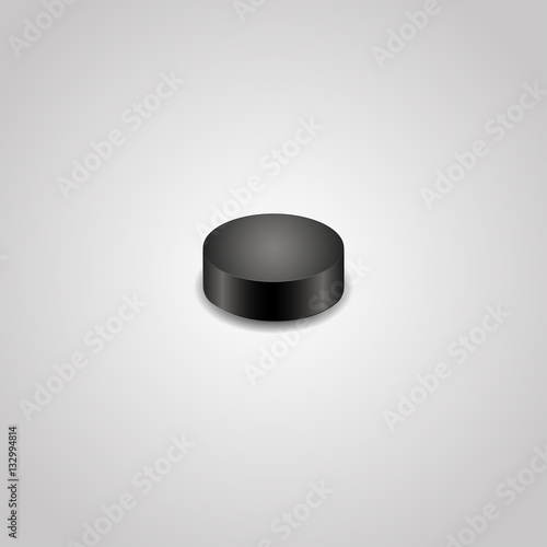 Hockey puck on a grey background