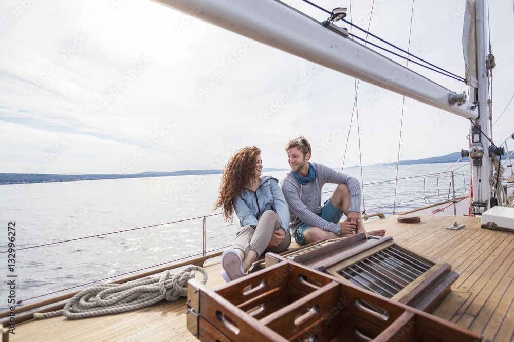 Young couple relaxing on boat deck of yacht Young couple relaxing on boat deck of yacht