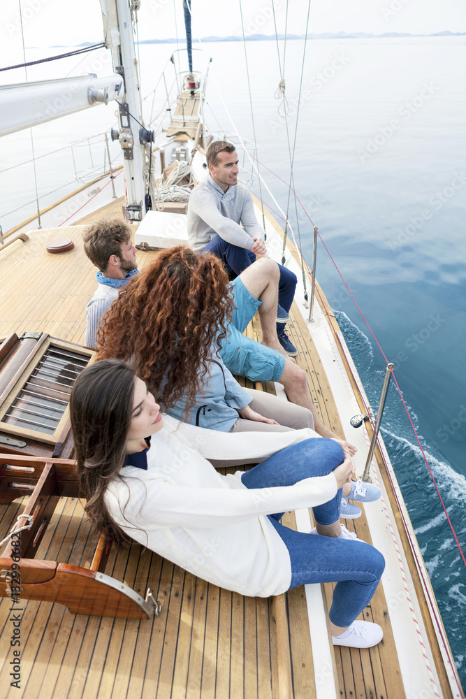 Group of friends relaxing on boat deck of yacht Group of friends relaxing on boat deck of yacht