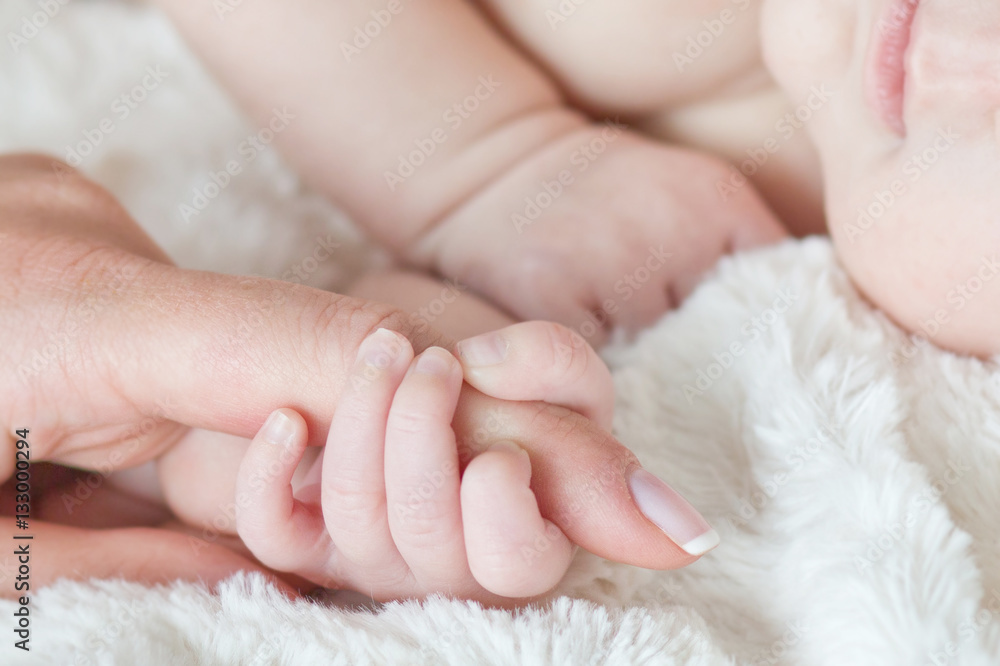 Hand the sleeping baby in the hand of mother close-up .Soft focu