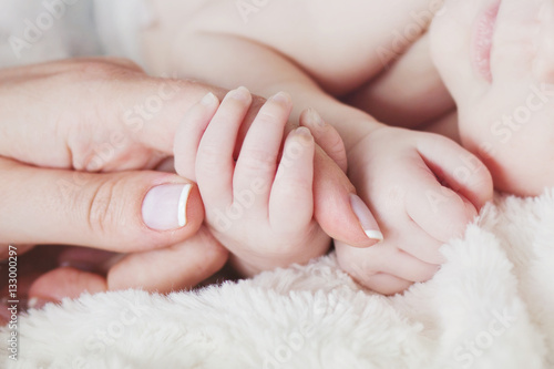 Hand the sleeping baby in the hand of mother close-up .Soft focu