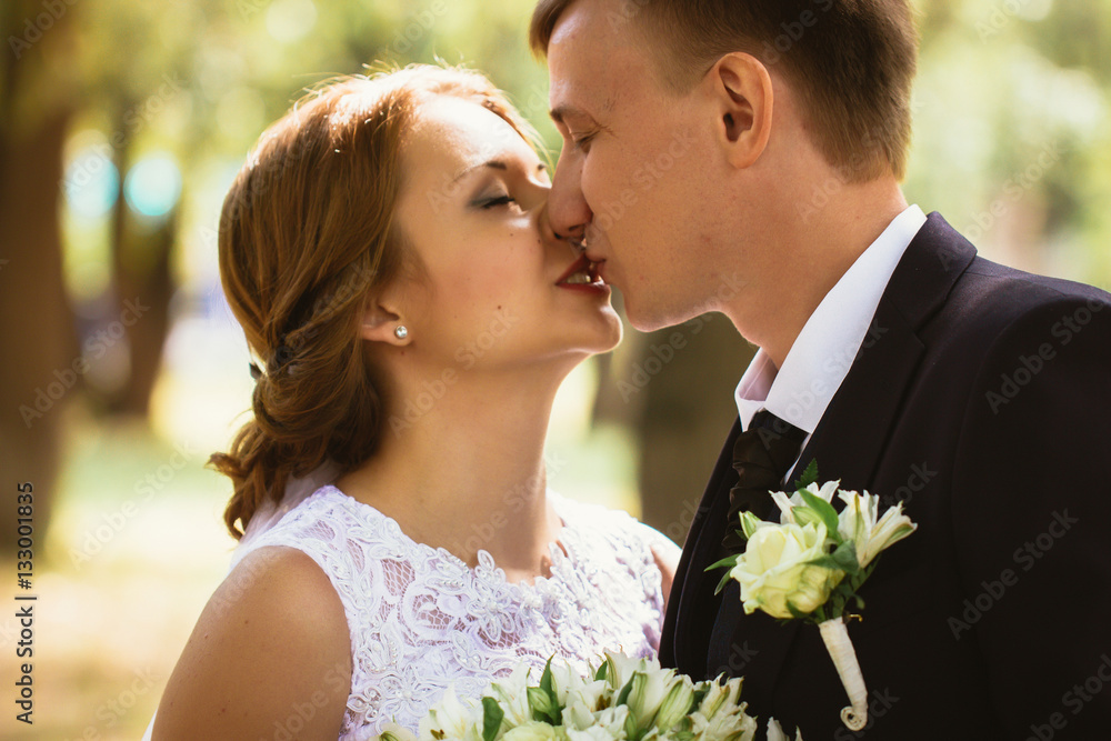 portrait of a couple bride and groom on park background portrait of a couple bride and groom on park background