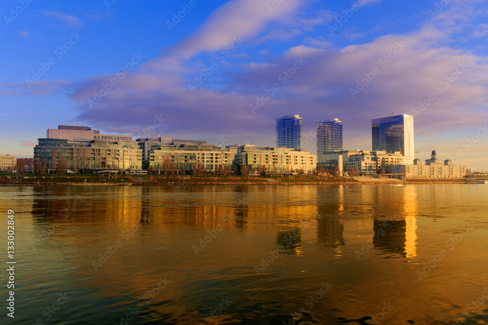 Bratislava modern skyscapers, near Danube river, gold reflection