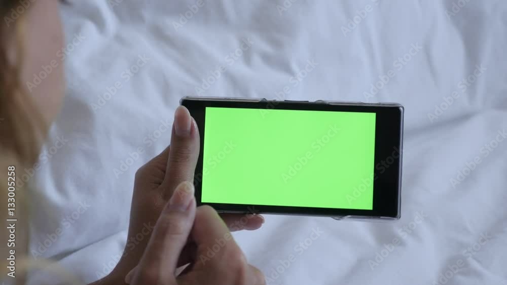 Woman holds greenscreen tablet while relaxing at home 4K 2160p 30fps UltraHD footage - Female in bed with green screen smart phone 3840X2160 UHD video Woman holds greenscreen tablet while relaxing at home 4K 2160p 30fps UltraHD footage - Female in bed with green screen smart phone 3840X2160 UHD video