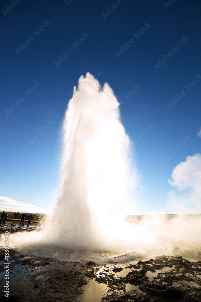 Strokkur Geysir Eruption against the Sun, Iceland Strokkur Geysir Eruption against the Sun, Iceland