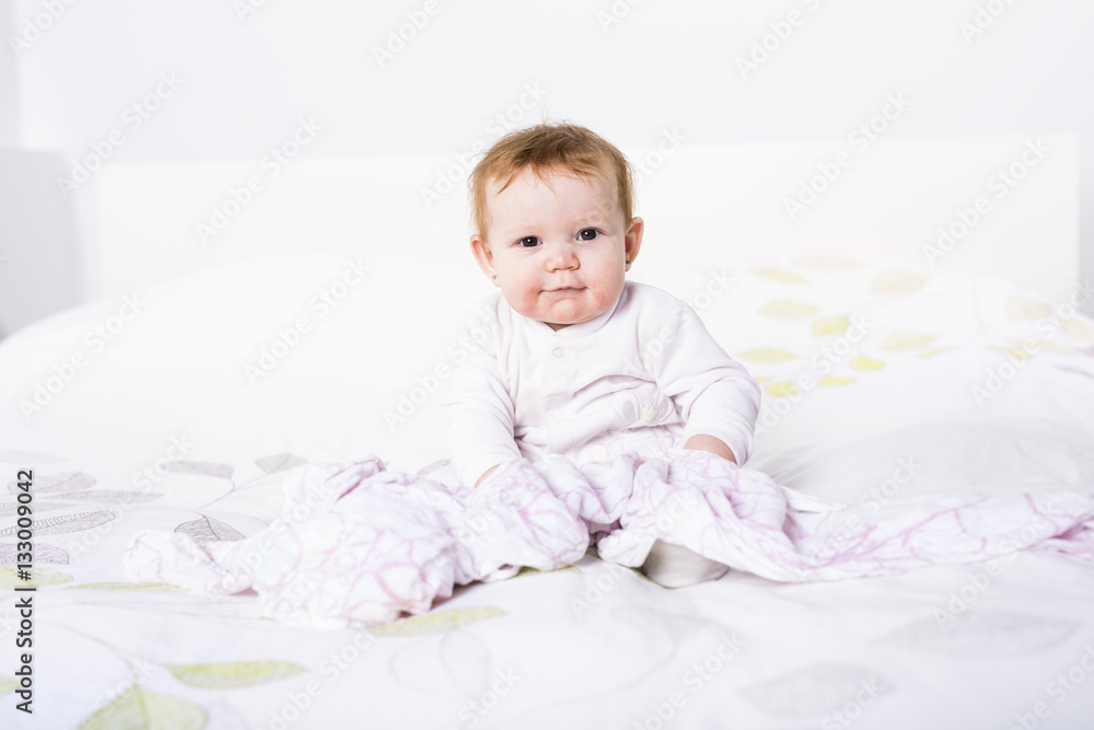 Portrait of a crawling baby on the bed in her room Portrait of a crawling baby on the bed in her room