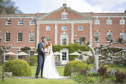 Bride and bridegroom with mansion in background